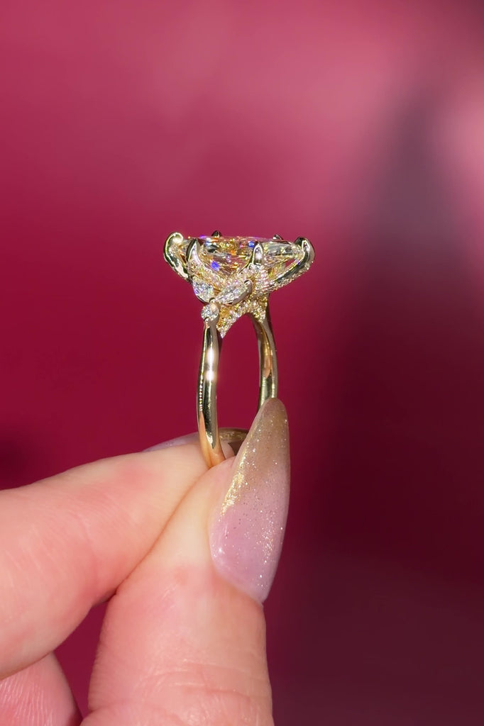 3.01ct F-VVS2 Marquise Lab Diamond Olivia. Three stone style engagement ring featuring two marquise and one round diamond at the bottom of the tro. The marquise act as diamond leaves holding the center stone. From the side profile the Olivia features a diamond bridge and diamond petal prongs.