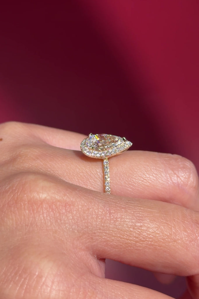 pear lab diamond yellow gold halo engagement ring pave band diamond petal prong basket on hand