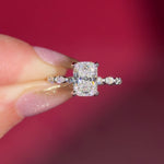 The Rei is a traditional style engagement ring featuring a hidden halo set between the prongs, adding subtle sparkle beneath the center stone.

The standout detail of this design is the floating marquise and round side diamonds, each held by a single prong. This setting allows each side diamond to be fully visible from every angle, creating a light, airy, and elegant look.

Because of this construction, Rei is a more delicate and high maintenance style, best suited for those who are mindful with daily wear 