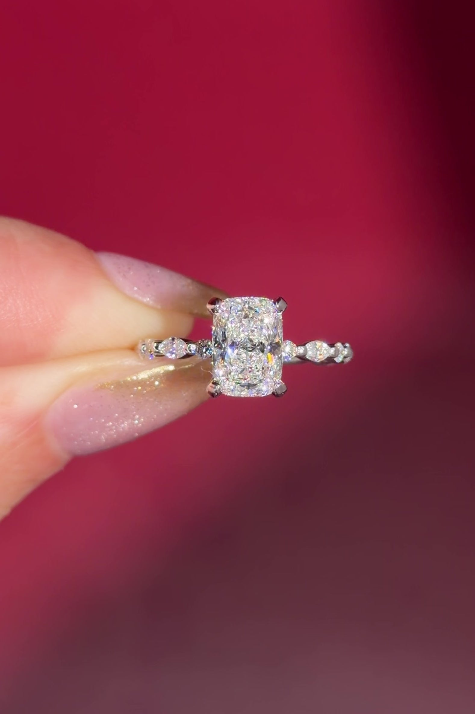 The Rei is a traditional style engagement ring featuring a hidden halo set between the prongs, adding subtle sparkle beneath the center stone.

The standout detail of this design is the floating marquise and round side diamonds, each held by a single prong. This setting allows each side diamond to be fully visible from every angle, creating a light, airy, and elegant look.

Because of this construction, Rei is a more delicate and high maintenance style, best suited for those who are mindful with daily wear 