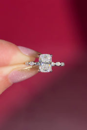 The Rei is a traditional style engagement ring featuring a hidden halo set between the prongs, adding subtle sparkle beneath the center stone.

The standout detail of this design is the floating marquise and round side diamonds, each held by a single prong. This setting allows each side diamond to be fully visible from every angle, creating a light, airy, and elegant look.

Because of this construction, Rei is a more delicate and high maintenance style, best suited for those who are mindful with daily wear 