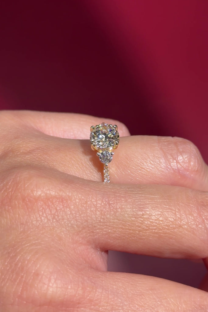 round lab diamond pave yellow gold engagement ring side stones trio on hand