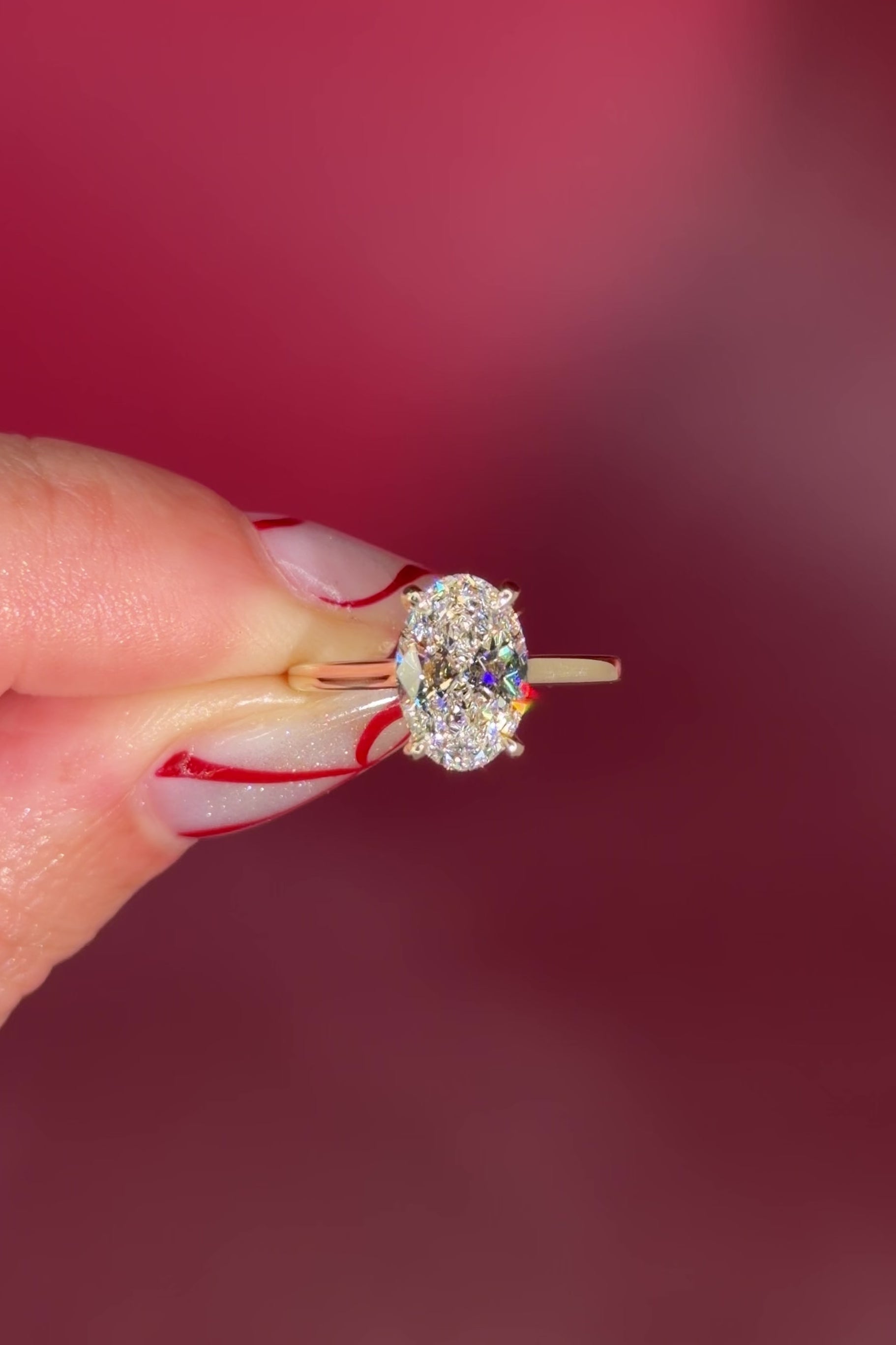 Oval solitaire with hidden halo and diamond bridge in yellow gold