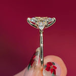 marquise yellow gold engagement ring with pear side stones