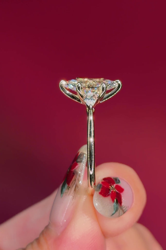 marquise yellow gold engagement ring with pear side stones