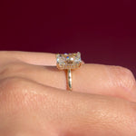 radiant lab diamond yellow gold solitaire engagement ring cathedral setting with diamond bridge on hand