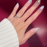 pear lab diamond solitaire engagement ring with cathedral and belt on hand