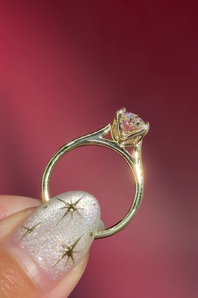 classic oval lab diamond solitaire engagement ring yellow gold cathedral setting petal prong basket