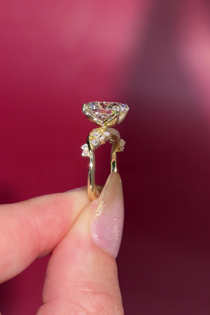 3.04ct E-VVS2 Oval Lab Diamond Ariel. The Ariel engagement ring is inspired by the sea. A unique twist on the classic Nova design, Ariel features a captivating center stone enveloped by wave-like contours. Delicate diamond bubble side stones, reminiscent of ocean bubbles, add a whimsical touch. Crafted precisely, this ring seamlessly blends timeless elegance with an underwater allure.