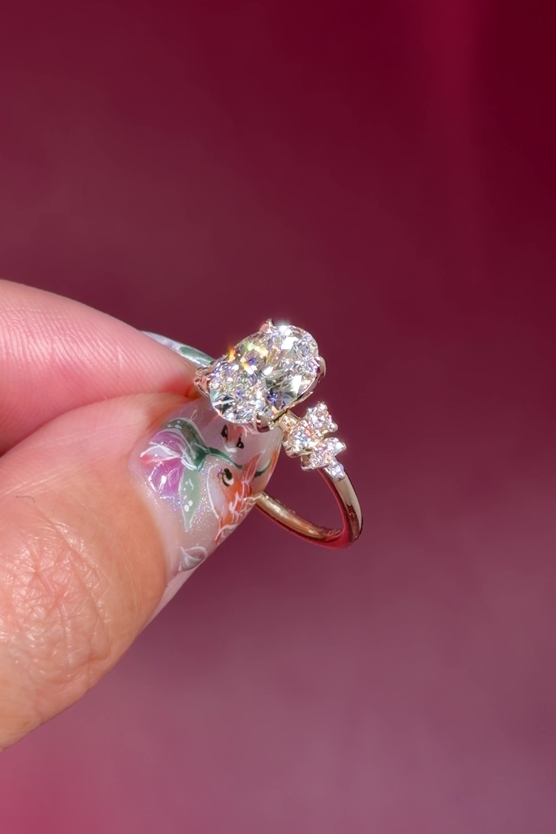 oval lab diamond engagement ring side stone cluster nature inspired yellow gold setting with petal prong basket