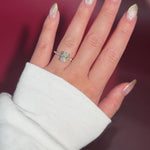 The Rei is a traditional style engagement ring featuring a hidden halo set between the prongs, adding subtle sparkle beneath the center stone.

The standout detail of this design is the floating marquise and round side diamonds, each held by a single prong. This setting allows each side diamond to be fully visible from every angle, creating a light, airy, and elegant look.

Because of this construction, Rei is a more delicate and high maintenance style, best suited for those who are mindful with daily wear 