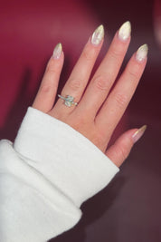 The Rei is a traditional style engagement ring featuring a hidden halo set between the prongs, adding subtle sparkle beneath the center stone.

The standout detail of this design is the floating marquise and round side diamonds, each held by a single prong. This setting allows each side diamond to be fully visible from every angle, creating a light, airy, and elegant look.

Because of this construction, Rei is a more delicate and high maintenance style, best suited for those who are mindful with daily wear 