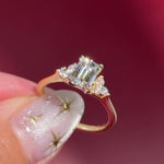 emerald lab diamond engagement ring trio side stone cluster yellow gold