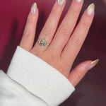 2.01ct F-VVS2 Pear Lab Diamond Sarah. The Sarah features a tapered high polish comfort fit band with a trio of diamonds. The trio features two marquises and one round diamond. The baskets are all lifted to fit a straight band flush against the body.