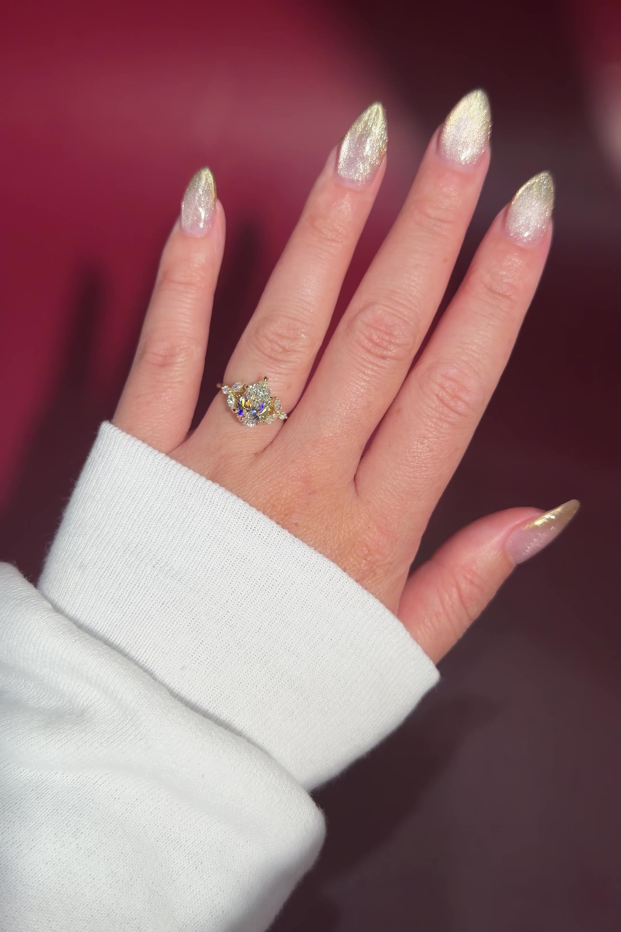 2.01ct F-VVS2 Pear Lab Diamond Sarah. The Sarah features a tapered high polish comfort fit band with a trio of diamonds. The trio features two marquises and one round diamond. The baskets are all lifted to fit a straight band flush against the body.