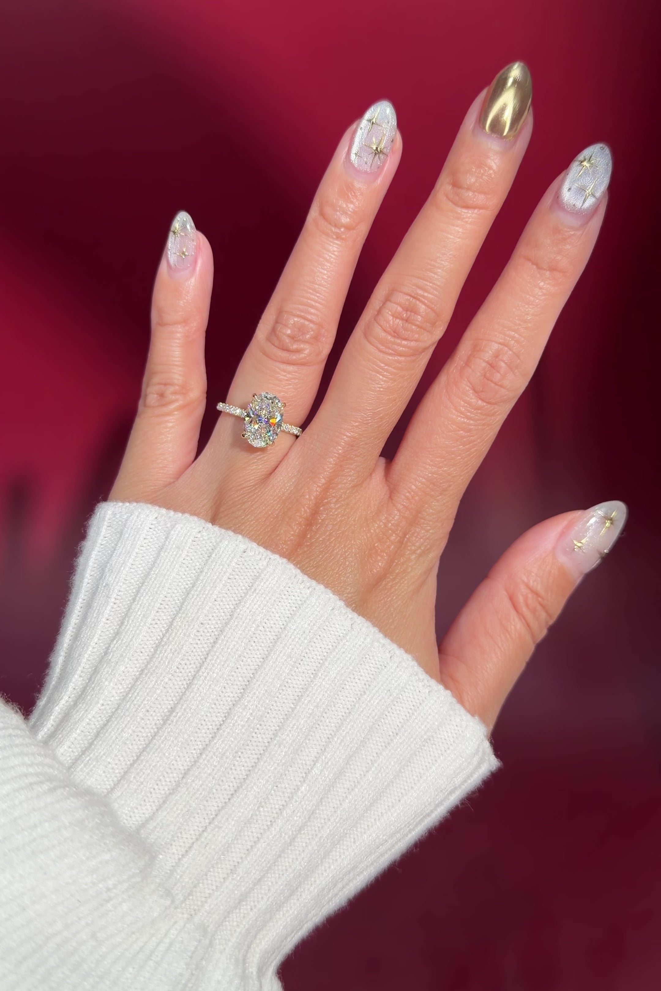 oval lab diamond engagement ring pavé band with diamond prongs and hidden halo on hand