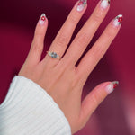 round yellow gold cluster petal prong engagement ring on hand