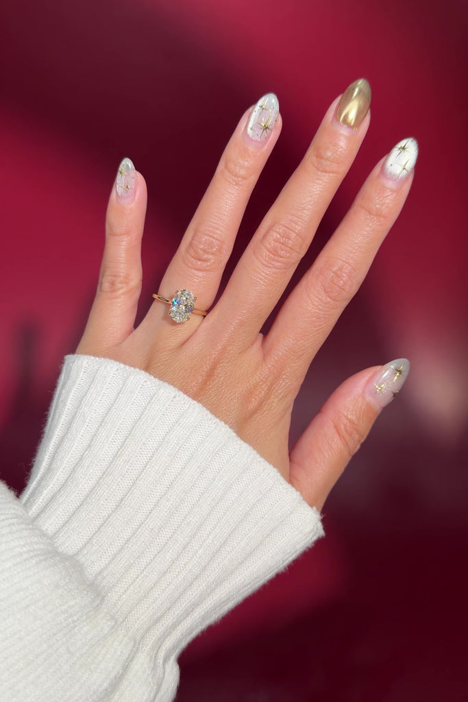 classic oval solitaire engagement ring yellow gold cathedral setting petal prong basket on hand