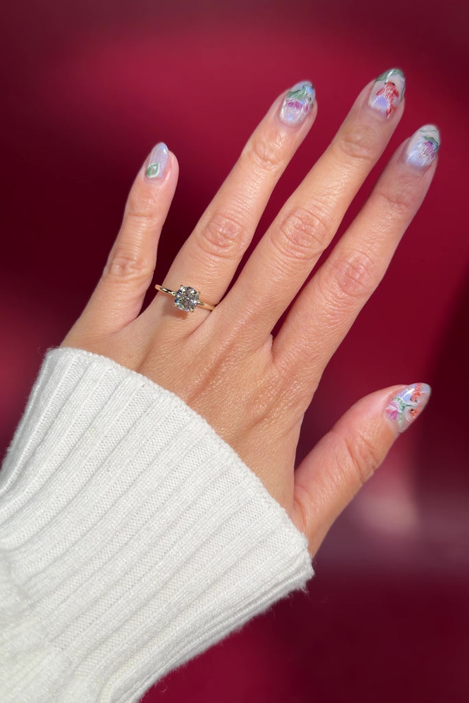 round solitaire classic engagement ring high polish plain yellow gold band four prongs on hand