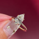 pear lab diamond solitaire engagement ring with flower petal prong basket yellow gold