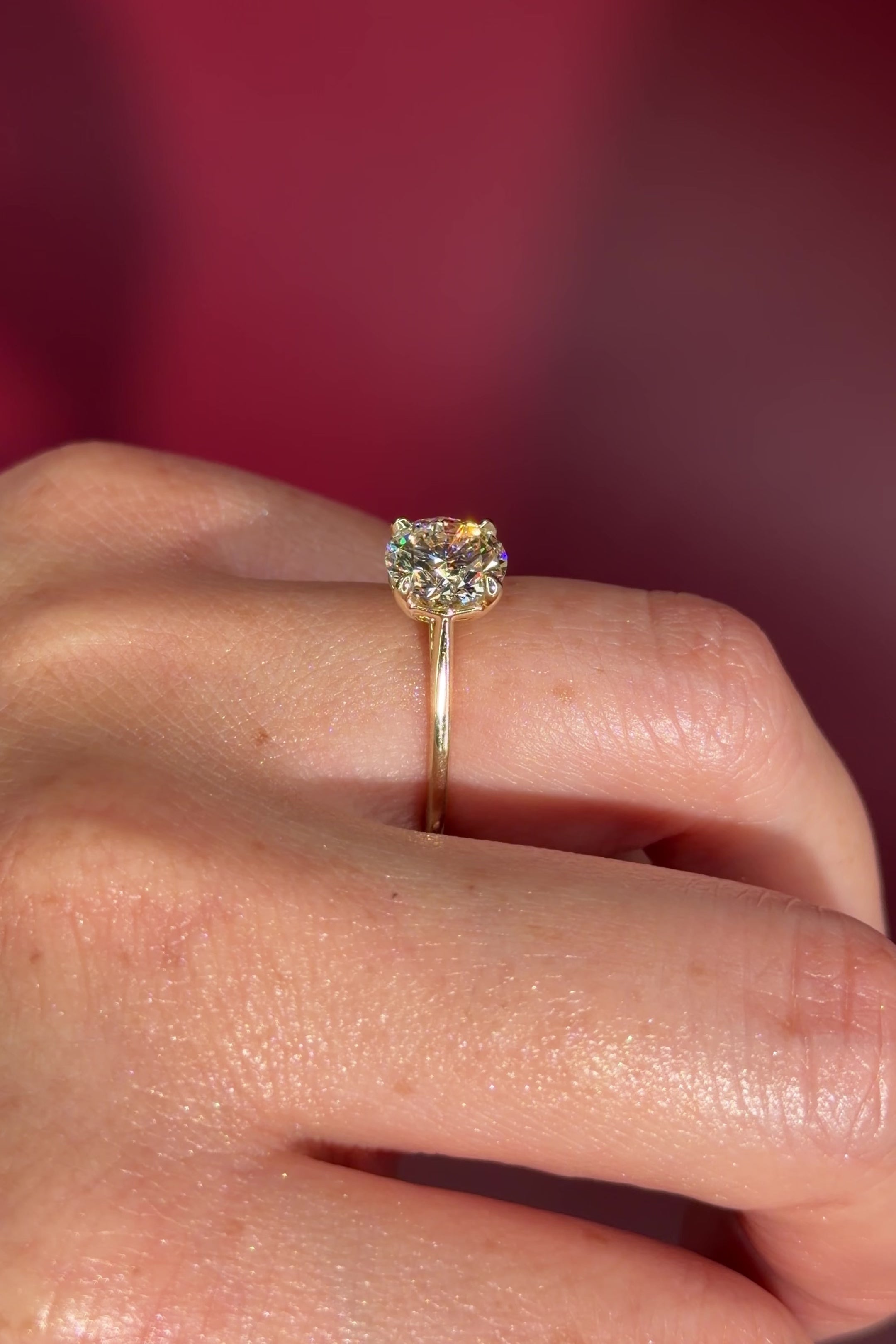 round yellow gold cathedral solitaire 4-prongs yellow gold on hand