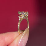 2.01ct F-VVS2 Pear Lab Diamond Sarah. The Sarah features a tapered high polish comfort fit band with a trio of diamonds. The trio features two marquises and one round diamond. The baskets are all lifted to fit a straight band flush against the body.