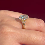 oval lab diamond nature inspired twist band engagement ring yellow gold cluster side stone setting on hand
