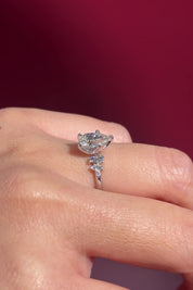 pear lab diamond cluster white gold nature inspired engagement ring with petal prong basket on hand