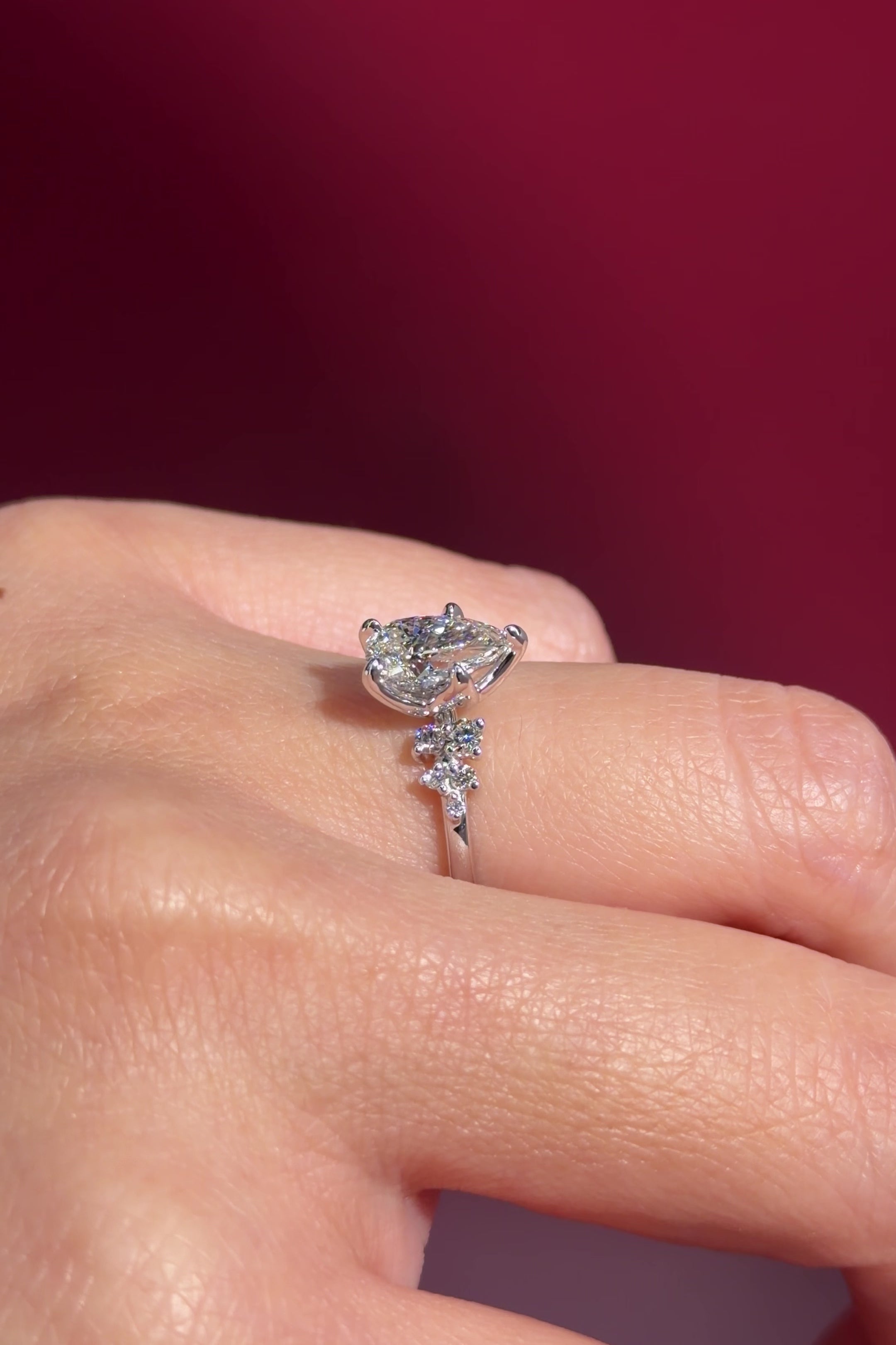 pear lab diamond cluster white gold nature inspired engagement ring with petal prong basket on hand