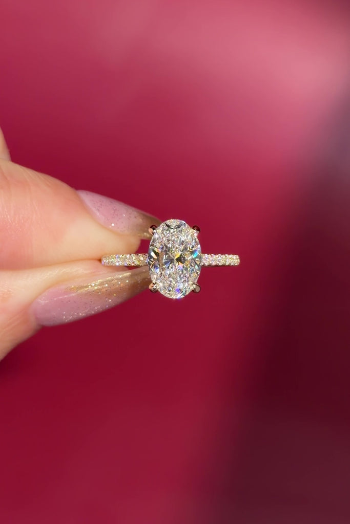 2.06ct D-VS1 Oval Lab Diamond Michelle. Cathedral style engagement ring with pavé diamonds going 75% around the ring, hidden halo, and high polish plain bridge made in solid 14k yellow gold.