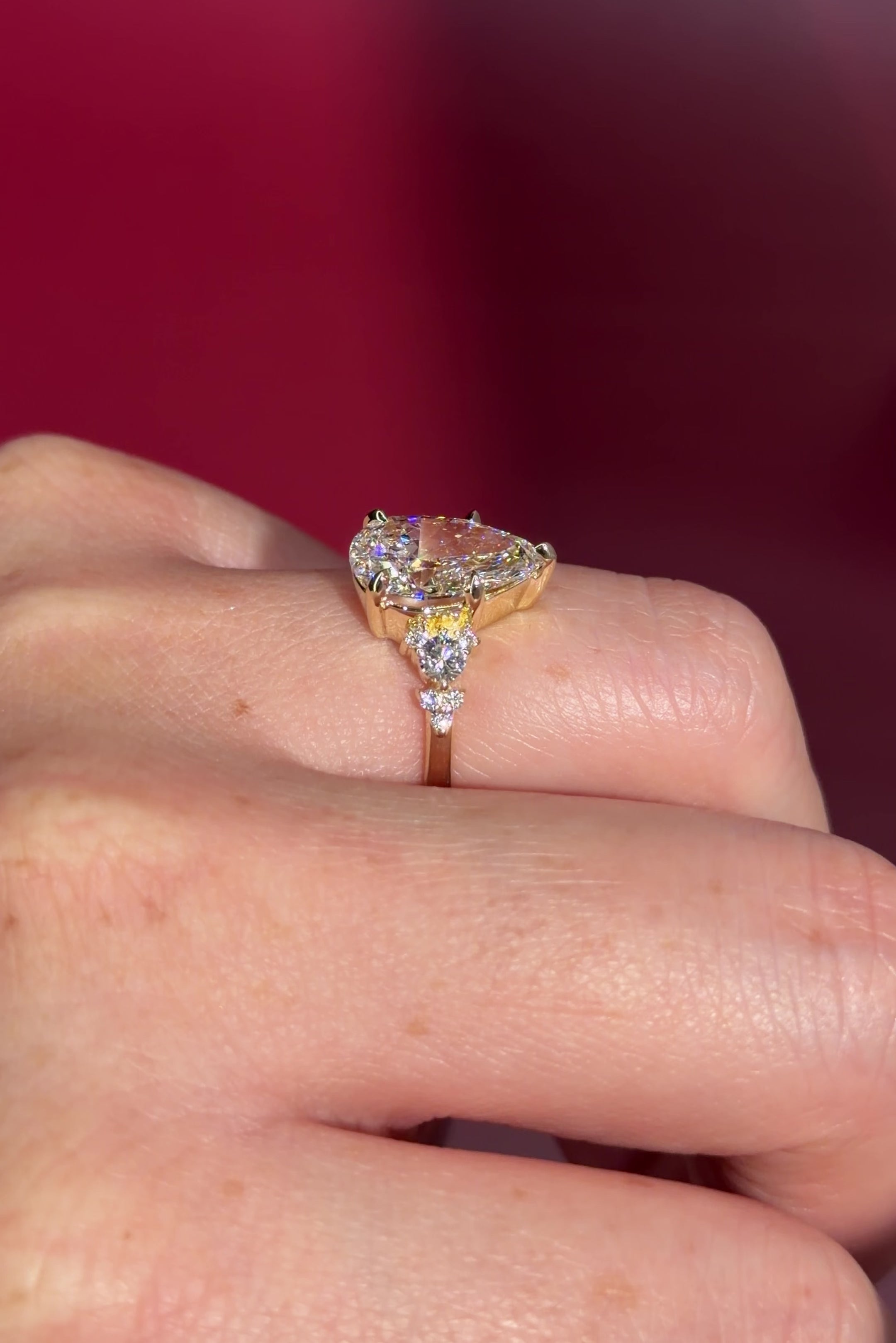 3.03ct D-VVS2 Pear Lab Diamond Brandi.

The Brandi is an inline style engagement ring featuring a symmetrical cluster of side diamonds that create a bold, sculptural look&nbsp;

Because of its inline design, straight wedding bands will not stack flush. This style pairs best with a curved or custom wedding band, or it can be worn beautifully on its own without a wedding band at all&nbsp;

A striking choice for those who love a statement engagement ring with intentional design details.