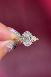 oval lab diamond cluster side stone nature inspired yellow gold engagement ring setting with petal prong basket