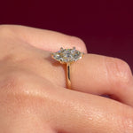 marquise lab diamond yellow gold cathedral setting high polish solitaire engagement ring on hand