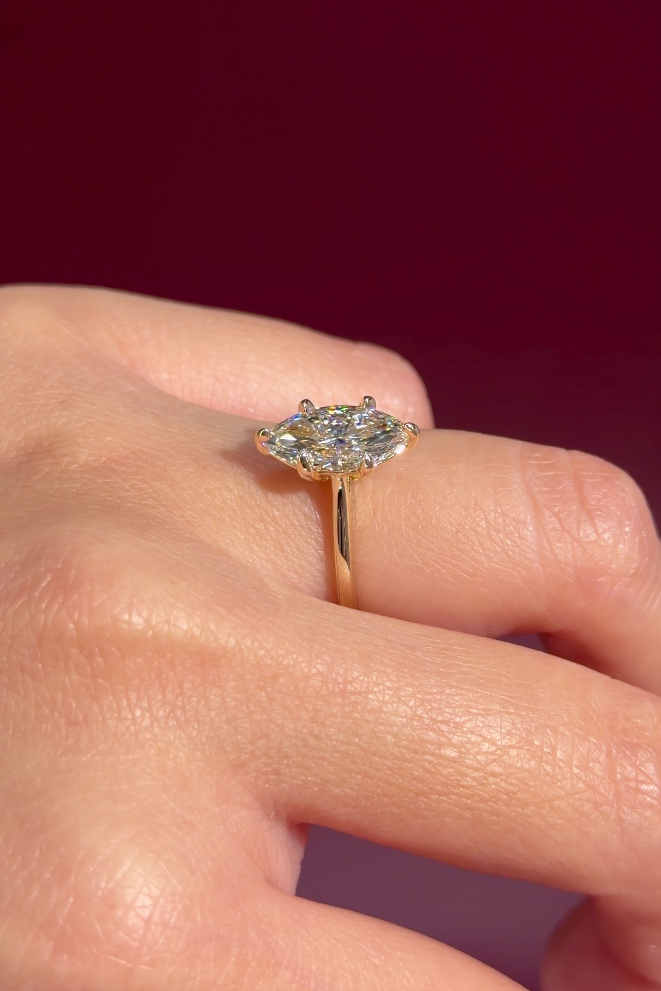 marquise lab diamond yellow gold cathedral setting high polish solitaire engagement ring on hand