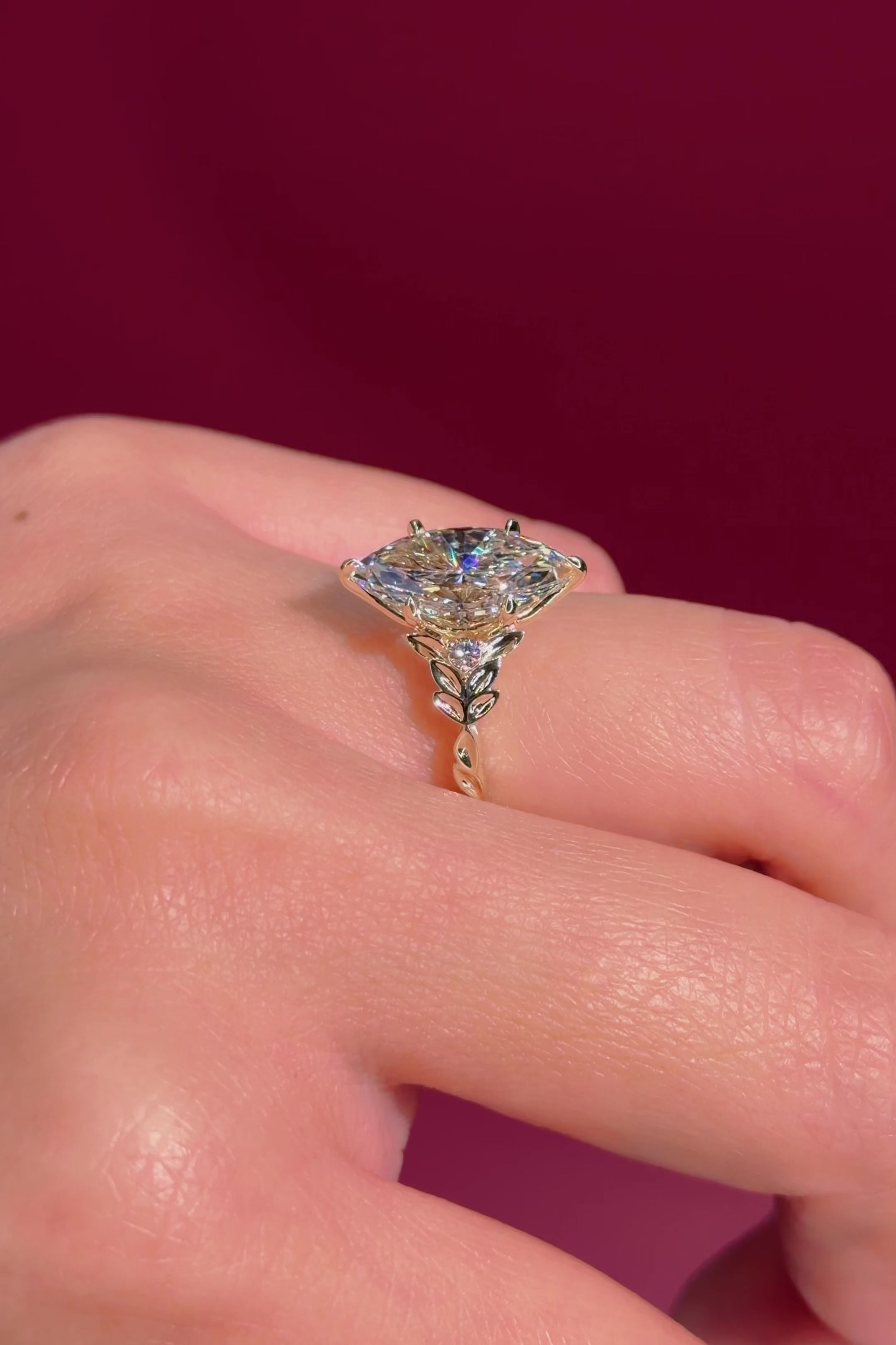 marquise diamond leafy nature inspired yellow gold engagement ring on hand