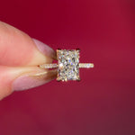 3.07ct F-VVS2 Radiant Lab Diamond Isabela. The Isabela is a cathedral style body with the key features being the pavé diamond lotus petal prongs and diamond bridge. This specific isabela is made with pavé side diamonds and is solid 14k yellow gold.