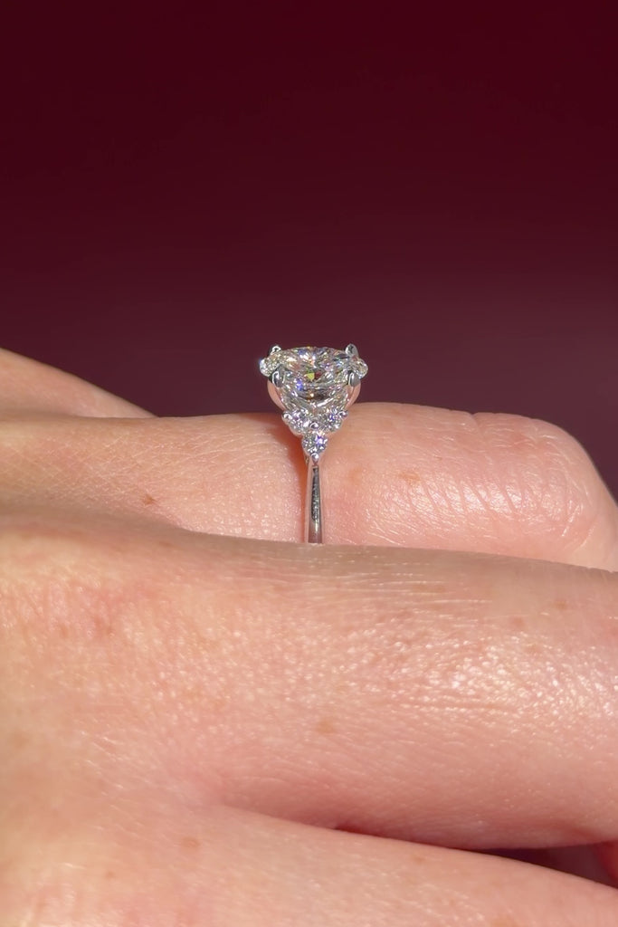 1.01ct D-VS1 Oval Lab Diamond Lindsey. The Lindsey features a classic high polish band with a trio of diamond side stones to perfectly accent your selected center stone.