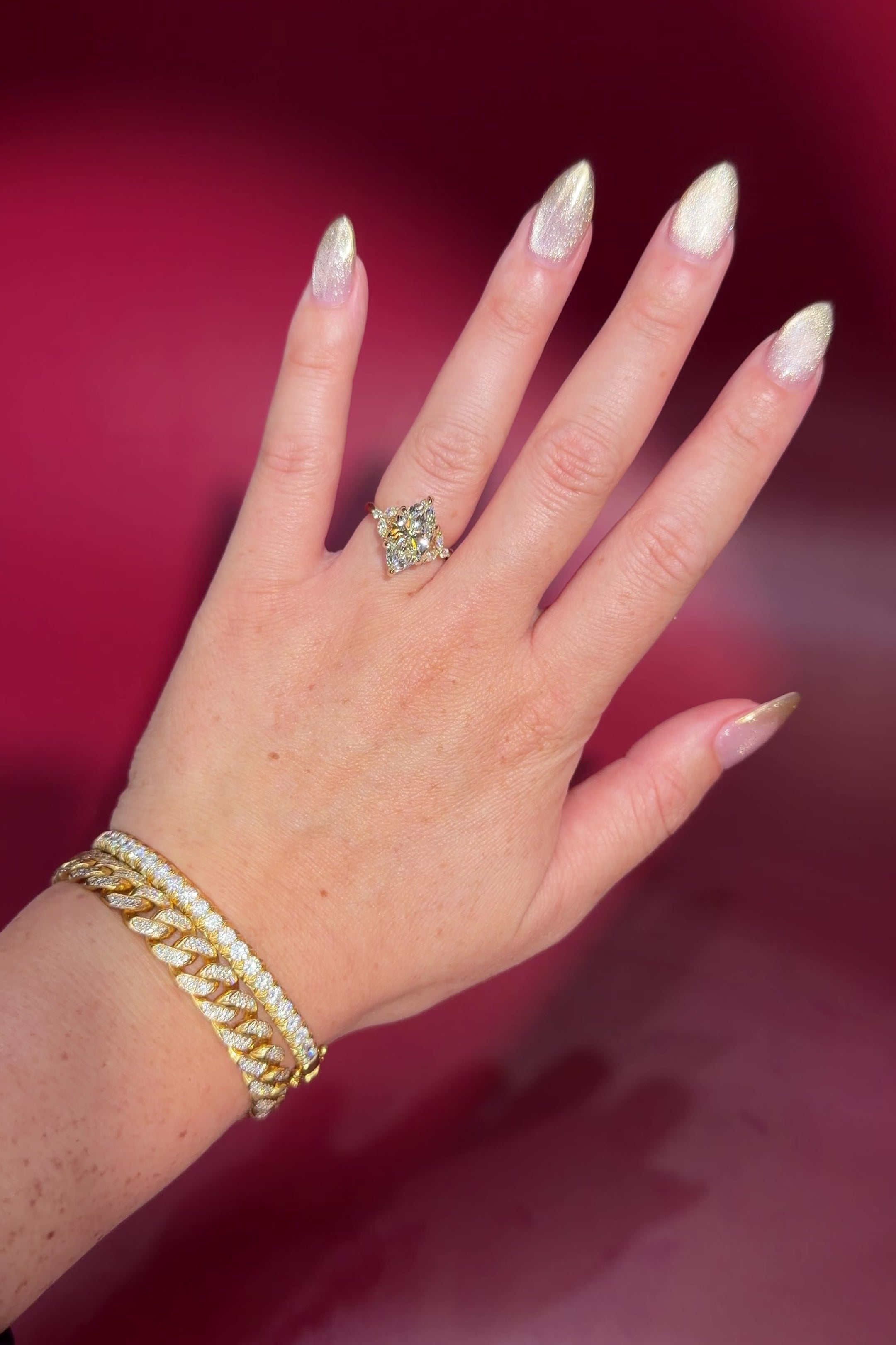 3.01ct F-VVS2 Marquise Lab Diamond Olivia. Three stone style engagement ring featuring two marquise and one round diamond at the bottom of the tro. The marquise act as diamond leaves holding the center stone. From the side profile the Olivia features a diamond bridge and diamond petal prongs.