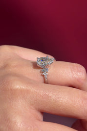 pear lab diamond nova engagement ring cluster side stones nature inspired white gold flower petal prong basket on hand