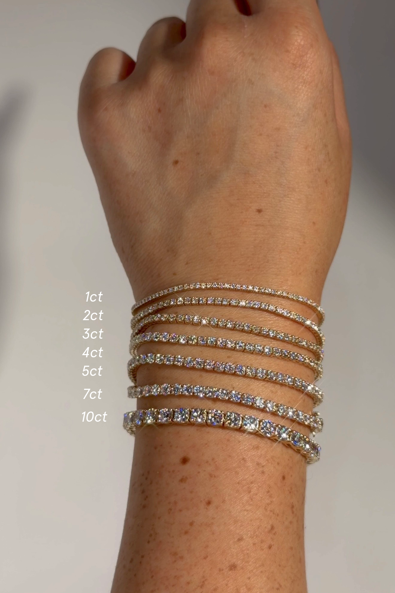 Diamond tennis bracelet carat size comparison from 1ct to 10ct in 14k yellow gold – lab-grown diamond bracelets shown side by side for visual scale and sparkle difference.